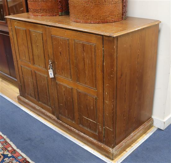 An Edwardian pine cupboard W.140cm